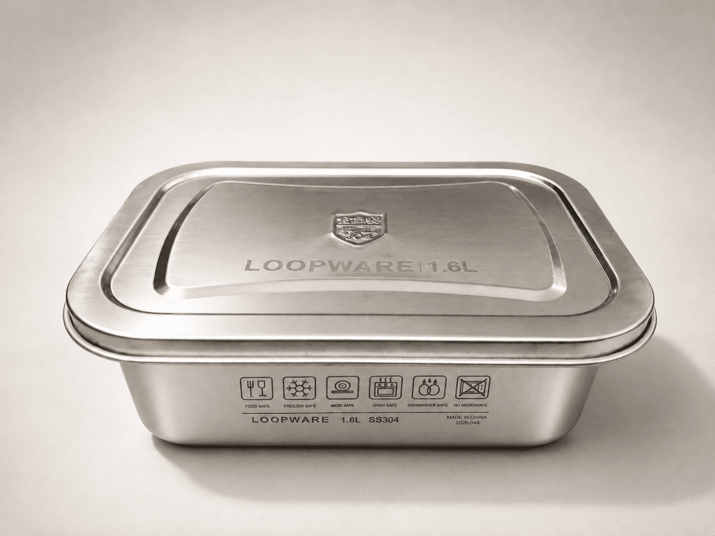 A Loopware 1.6L stainless steel container with its steel lid pressed on, the SS304 grade and use icons engraved on the body