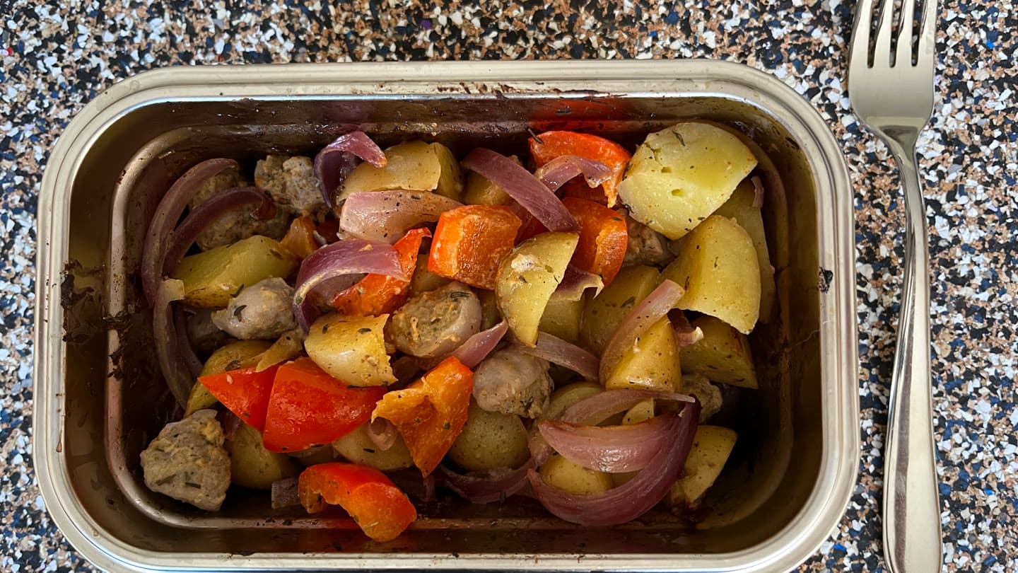 Sausage, potato, sweet pepper and red onion baked in a Loopware stainless steel cooking container